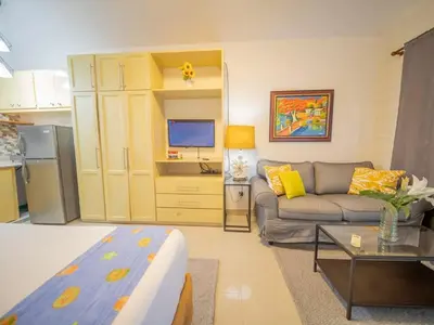 a living room with a couch and a tv at Studio in Sosua Center Near Sosua beach in Sosúa