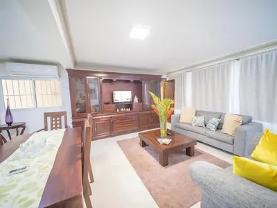 a living room with a couch and a table at Spacious 1BR APT in Sosua strip in Sosúa
