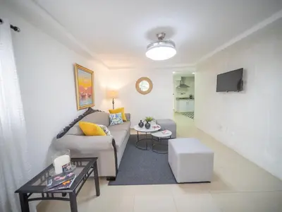 a living room with a couch and a table at Cozy & Central 3BR Apt Secure & Comfortable in Sosúa