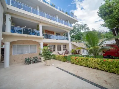 an exterior view of a building with a patio at Cozy & Central 3BR Apt Secure & Comfortable in Sosúa