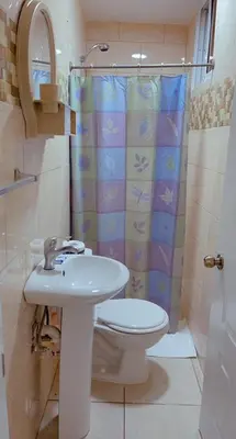a bathroom with a sink and a toilet and a shower at Cozy & Central 3BR Apt Secure & Comfortable in Sosúa