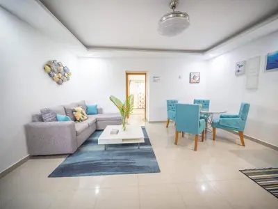 a living room with a couch and a table at Stylish 1BR Near Beach & Main Strip Sosua in Sosúa