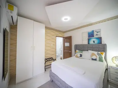 a bedroom with a large white bed in a room at Room in the center with Outdoor Jacuzzi in Sosúa