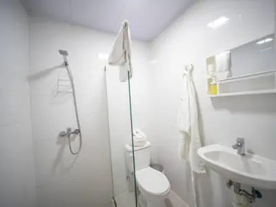 a bathroom with a shower and a toilet and a sink at Room in the center with Outdoor Jacuzzi in Sosúa