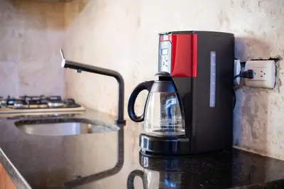 a coffee maker sitting on top of a counter at Getaway room with shared Jacuzzi in the center in Sosúa