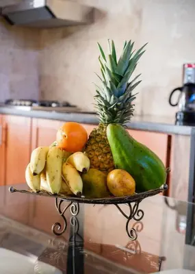 a plate of fruits and vegetables on a table at Getaway room with shared Jacuzzi in the center in Sosúa