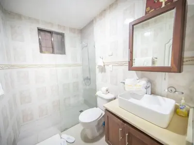 a bathroom with a sink and a toilet and a mirror at Affordable 1BR APT in Sosua Center - Strip Zone in Sosúa
