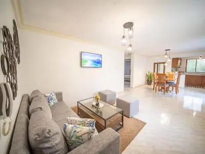 a living room with a couch and a table at Affordable 2BR APT in Sosua Center in Sosúa