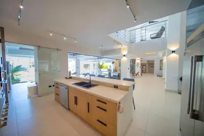 a large kitchen with a sink and a counter at Luxury villa with Private beach access in Sosúa