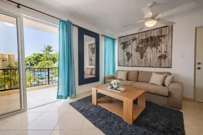 a living room with a couch and a table at Garden Condos APT 35 - Affordable 1BR APT in Sosua in Sosúa