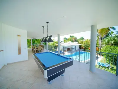 a pool table on a patio with a swimming pool at COZY 7BR Villa BIG POOL Close to beach in Sosúa