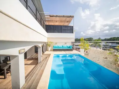 a swimming pool on the roof of a house at 4BR Penthouse with Rooftop Pool in Sosua strip in Sosúa