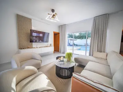 a living room with a couch and a tv at First class 4BR KING SIZE Villa in Sosua town in Sosúa
