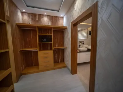 a walk in closet with wooden cabinets and a kitchen at Stylish Luxury Villa in Sosua- 5BR Suites in Sosúa