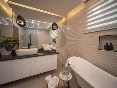 a bathroom with a tub and a sink and a mirror at Stylish Luxury Villa in Sosua- 5BR Suites in Sosúa