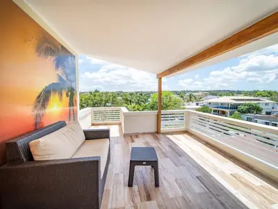 a living room with a couch and a table on a balcony at North Coast Luxury Villa in Sosua - 6BR Suites in Sosúa