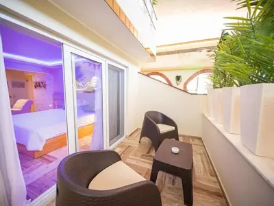 a room with two chairs and a bed and a window at North Coast Luxury Villa in Sosua - 6BR Suites in Sosúa