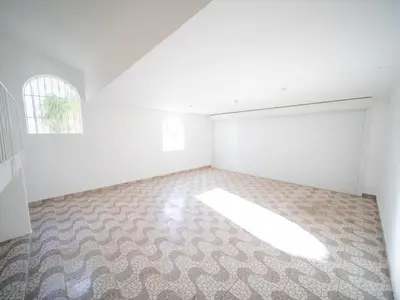 an empty room with a white garage with a window at Modern 5BR Private Villa in Sosua center in Sosúa