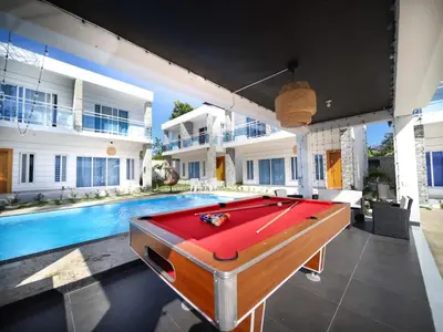 a pool table in front of a house with a pool at 8BR Private Villa in Sosua 2 mins from Nightlife in Sosúa