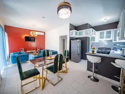a kitchen and living room with a table and a couch at 8BR Private Villa in Sosua 2 mins from Nightlife in Sosúa