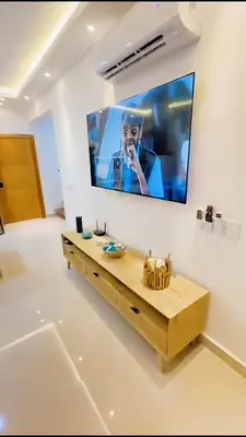 a television hanging on a wall in a living room at Caribbean Dream Bayahibe Seaside 3Br Penthouse in Bayahibe