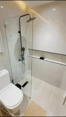 a bathroom with a toilet and a glass shower at Caribbean Dream Bayahibe Seaside 3Br Penthouse in Bayahibe
