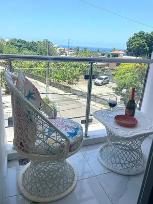 a balcony with a table and a bottle of wine at Royal Terrace Queen 1 in San Felipe de Puerto Plata