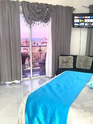 a bedroom with a bed and a large window at Royal Terrace Queen 1 in San Felipe de Puerto Plata
