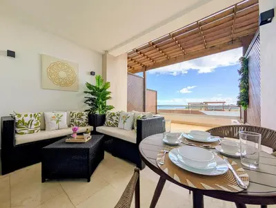 a living room with a table and chairs and a couch at Beautiful Apartment overlooking Samaná Bay