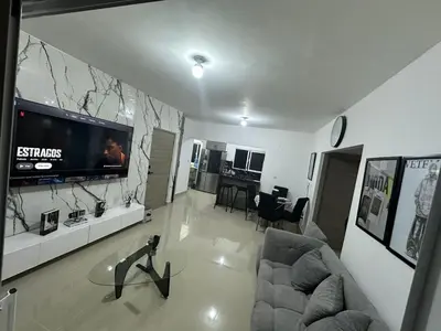 a living room with a flat screen tv on a wall at Residential hammock 2, next to the brewery in Concepción de La Vega