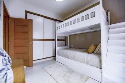 a small bedroom with a bunk bed and a staircase at A Tropical Oasis - Vista Canas Villa Vista in Punta Cana