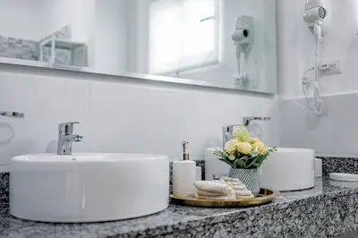 a bathroom counter with a sink and a mirror at A Tropical Oasis - Vista Canas Villa Vista in Punta Cana