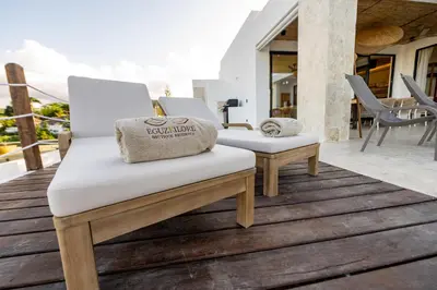 a pair of white chairs on the deck of a house at Villa Libelula, Ocean View, Private Pool,3 Suites in El Limón