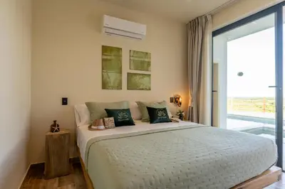 a bedroom with a large bed and a large window at Villa Libelula, Ocean View, Private Pool,3 Suites in El Limón