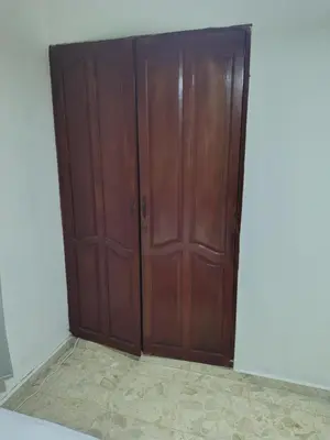 a pair of wooden doors in a room at Double bed room in Santo Domingo