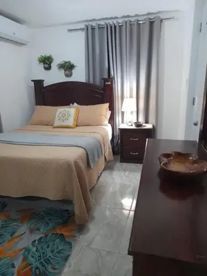 a bedroom with a bed and a coffee table at Cozy Romance Apartment-Couples Only in Santiago de los Caballeros
