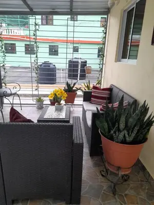 a patio with couches and potted plants at Cozy Romance Apartment-Couples Only in Santiago de los Caballeros