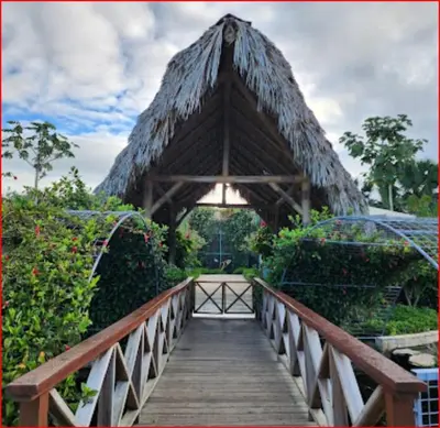 a wooden bridge with a covering over a walkway at Cozy Romance Apartment-Couples Only in Santiago de los Caballeros