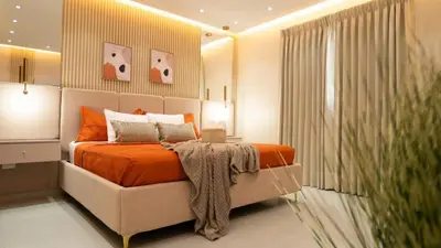 a bedroom with a bed with an orange blanket on it at Luxurious 3-Bedroom Retreat in Santiago de los Caballeros in Santiago de los Caballeros