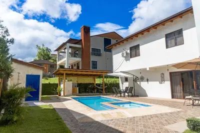 a villa with a swimming pool and a house at Our dreams house in Jarabacoa