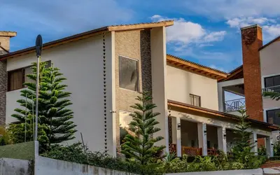 a house with a tree in front of it at Our dreams house in Jarabacoa