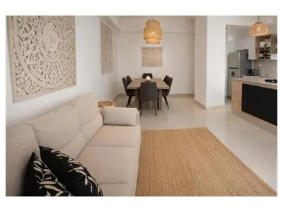 a living room with a couch and a dining table at Apartement cosy et lumineux in Cuevas