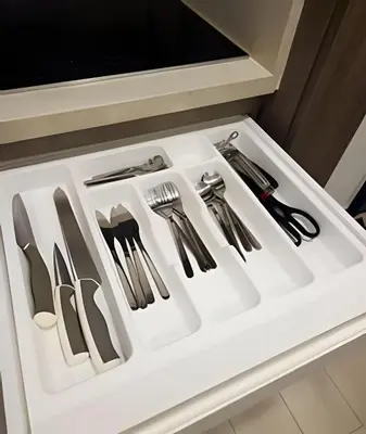 a white drawer filled with utensils in a kitchen at Condominio de lujo Salida a playa Estilo Resort Muchas comodidades: 6 piscinas/TV/aire acondicionado in Punta Cana
