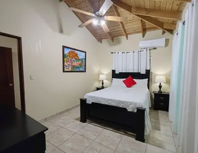 a bedroom with a bed and a ceiling fan at Aura Azul in Sosua