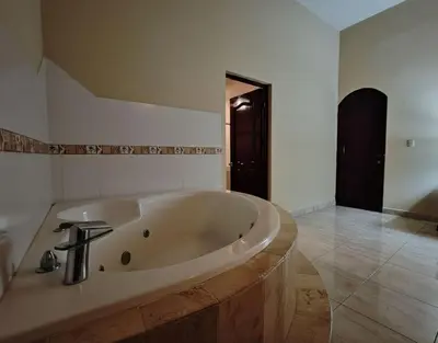 a large white bath tub in a bathroom at Aura Azul in Sosua