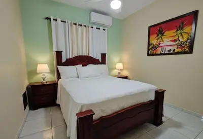 a bedroom with a large bed with two night stands at Aura Azul in Sosua