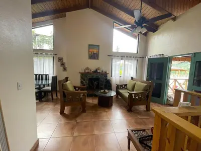 a living room with chairs and a ceiling fan at cabaña de renta en Jarabacoa in Jarabacoa