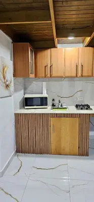 a kitchen with a sink and a microwave at Coco house by Julio 2 in Nagua