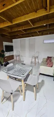 a living room with a table and chairs and a couch at Coco house by Julio 2 in Nagua