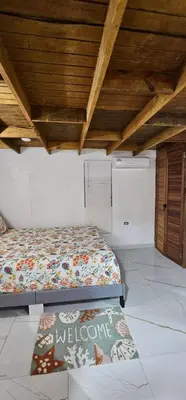 a bed in a room with a wooden ceiling at Coco house by Julio 2 in Nagua